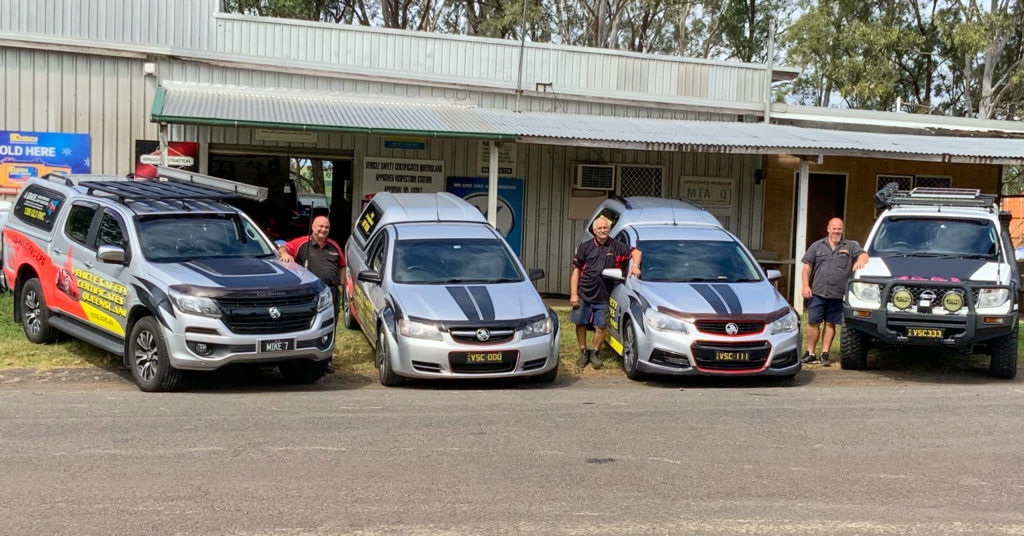 VSCQ team with the VSCQ vehicles out the front of the VSCQ depot